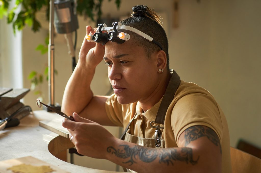 Black female jeweler creating handmade ring